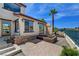 Backyard featuring a patio with water view and lush landscaping at 2708 Port Of Call Dr, Las Vegas, NV 89128
