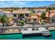 Exterior of a waterfront home with a dock and outdoor seating at 2708 Port Of Call Dr, Las Vegas, NV 89128