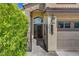 Inviting front entrance with a decorative iron gate, stone accents, and a well-manicured lawn at 2708 Port Of Call Dr, Las Vegas, NV 89128