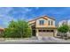 Charming two-story home featuring a tile roof, arched entryway, and well-manicured landscaping at 2708 Port Of Call Dr, Las Vegas, NV 89128