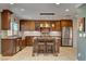 Charming kitchen features custom cabinets, stainless appliances, and central island at 2708 Port Of Call Dr, Las Vegas, NV 89128