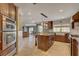 Open-concept kitchen boasts island, custom cabinets, and modern appliances at 2708 Port Of Call Dr, Las Vegas, NV 89128