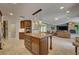 Open kitchen with custom cabinets, granite island, and seamless flow to the living area at 2708 Port Of Call Dr, Las Vegas, NV 89128