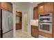 Kitchen with stainless steel appliances and custom wood cabinets at 2708 Port Of Call Dr, Las Vegas, NV 89128
