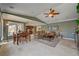 Open-concept living room and dining area with stone floors and plenty of natural light at 2708 Port Of Call Dr, Las Vegas, NV 89128