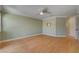 Spacious living room featuring hardwood floors, neutral walls, ceiling fan, and natural light at 2708 Port Of Call Dr, Las Vegas, NV 89128
