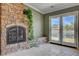 Serene living room with a stone fireplace and views of the outdoor scenery at 2708 Port Of Call Dr, Las Vegas, NV 89128