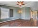 Large living room with hardwood floors, ample natural light, and a ceiling fan at 2708 Port Of Call Dr, Las Vegas, NV 89128