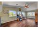 Upstairs loft with hardwood floors, large windows with water views, and comfortable seating at 2708 Port Of Call Dr, Las Vegas, NV 89128