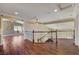 Well-lit loft with hardwood floors, decorative railing, and open space concept at 2708 Port Of Call Dr, Las Vegas, NV 89128