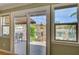 View from inside the home of the outdoor patio with stone pillars and outdoor seating overlooking the water at 2708 Port Of Call Dr, Las Vegas, NV 89128