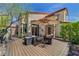 Beautiful patio featuring a fire pit, umbrella, stone accents, and meticulous landscaping at 2708 Port Of Call Dr, Las Vegas, NV 89128