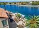 Waterfront property with a private dock, stone patio, and lush landscaping, perfect for outdoor enjoyment at 2708 Port Of Call Dr, Las Vegas, NV 89128