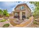 Backyard features a covered patio, manicured landscaping, and decorative rock pathway at 2711 Evolutionary Ln, Las Vegas, NV 89138