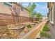 Picturesque backyard with a decorative rock garden and desert landscaping at 2711 Evolutionary Ln, Las Vegas, NV 89138