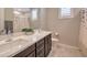 Bathroom features a double sink vanity with quartz countertop and tiled floors at 2711 Evolutionary Ln, Las Vegas, NV 89138
