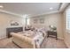 Neutral bedroom boasts a tufted headboard, soft carpet, and shutters for a cozy retreat at 2711 Evolutionary Ln, Las Vegas, NV 89138