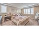 Bright bedroom featuring neutral tones, plantation shutters, plush bedding, and soft carpeting at 2711 Evolutionary Ln, Las Vegas, NV 89138