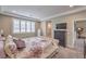 Comfortable bedroom with a queen-sized bed, dark dresser, large window, and an attached bathroom at 2711 Evolutionary Ln, Las Vegas, NV 89138