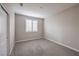 Neutral bedroom with gray carpet, plantation shutters, and a spacious closet at 2711 Evolutionary Ln, Las Vegas, NV 89138