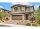 Attractive two-story home featuring a brick driveway, landscaped yard, and an inviting front porch at 2711 Evolutionary Ln, Las Vegas, NV 89138