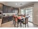 Eat-in kitchen features dark cabinets, light countertops and stainless steel appliances at 2711 Evolutionary Ln, Las Vegas, NV 89138