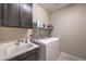 Well-organized laundry room with modern washer/dryer, sink, and overhead cabinets at 2711 Evolutionary Ln, Las Vegas, NV 89138