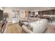 Open-concept living room and kitchen with a large sectional couch and stainless steel appliances at 2711 Evolutionary Ln, Las Vegas, NV 89138
