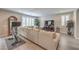 Bright living room with large sectional sofa, hardwood floors, and a modern entertainment center at 2711 Evolutionary Ln, Las Vegas, NV 89138