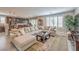 Spacious living room with plantation shutters, a comfortable sectional, and hardwood floors at 2711 Evolutionary Ln, Las Vegas, NV 89138