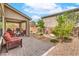 Inviting outdoor patio with comfortable seating, a dining set, and meticulous landscaping at 2711 Evolutionary Ln, Las Vegas, NV 89138