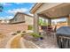 Inviting covered patio with a stone tile floor and complete outdoor dining set at 2711 Evolutionary Ln, Las Vegas, NV 89138