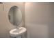 Neutral-colored powder room features a pedestal sink with mirror at 2711 Evolutionary Ln, Las Vegas, NV 89138
