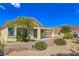 Rear exterior of home with covered patio and a view of the desert landscape at 2713 Rue Toulouse Ave, Henderson, NV 89044