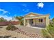 Rear exterior of home with covered patio and low maintenance desert landscaping at 2713 Rue Toulouse Ave, Henderson, NV 89044