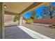 Covered patio overlooks the backyard with desert landscaping and privacy wall at 2713 Rue Toulouse Ave, Henderson, NV 89044