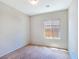Bedroom featuring tan carpet and a window providing natural light at 2713 Rue Toulouse Ave, Henderson, NV 89044