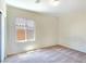 Bright bedroom with tan carpet, neutral walls, and a window overlooking the neighborhood at 2713 Rue Toulouse Ave, Henderson, NV 89044