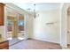 Dining area with tan carpet, sliding glass doors, and a decorative chandelier at 2713 Rue Toulouse Ave, Henderson, NV 89044