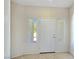 Bright entryway featuring tile flooring, a white front door, and sidelight windows at 2713 Rue Toulouse Ave, Henderson, NV 89044