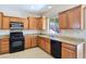 Well-lit kitchen featuring wooden cabinets, granite countertops, and stainless steel appliances at 2713 Rue Toulouse Ave, Henderson, NV 89044