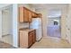 Kitchen area featuring light wood cabinets, tile flooring, and a white refrigerator at 2713 Rue Toulouse Ave, Henderson, NV 89044
