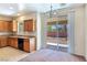 Eat-in kitchen area featuring wood cabinets, granite countertops, and sliding glass doors to the backyard at 2713 Rue Toulouse Ave, Henderson, NV 89044