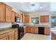 Well-equipped kitchen with wooden cabinets, black appliances, and tile flooring at 2713 Rue Toulouse Ave, Henderson, NV 89044