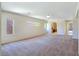 Spacious living room with neutral carpet, recessed lighting, and multiple windows at 2713 Rue Toulouse Ave, Henderson, NV 89044