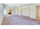 Open-concept living room with neutral carpet and views into the adjacent kitchen at 2713 Rue Toulouse Ave, Henderson, NV 89044