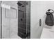 Modern bathroom featuring a sleek glass shower with black and white tiles and black hardware at 2724 Spear St, North Las Vegas, NV 89030