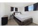 Inviting bedroom with modern bed frame, neutral carpet, and ample natural light from two windows at 2724 Spear St, North Las Vegas, NV 89030