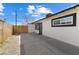 Rear view of home featuring a fenced yard, concrete driveway, and gravel landscaping at 2724 Spear St, North Las Vegas, NV 89030
