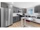 Bright kitchen with stainless steel refrigerator, gray cabinets and eat in counter at 2724 Spear St, North Las Vegas, NV 89030